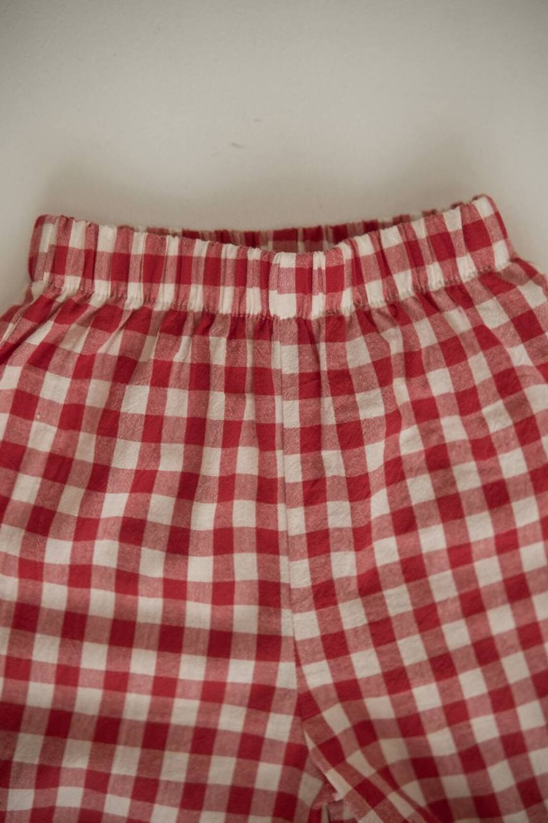 Light trousers with ruffles made from boiled red butter. New collection 
